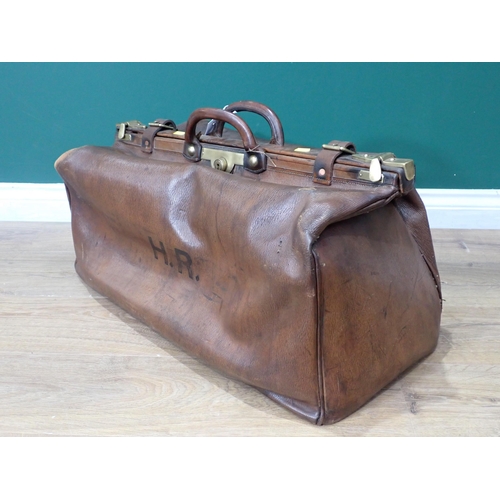 307 - An old leather Doctor's Bag with brass fittings and a Tea Trolley on barley twist supports