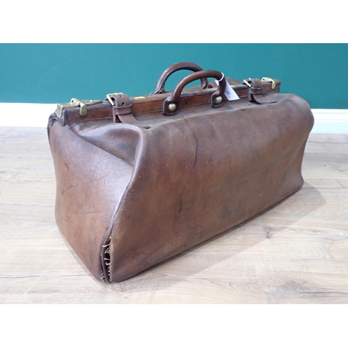 307 - An old leather Doctor's Bag with brass fittings and a Tea Trolley on barley twist supports