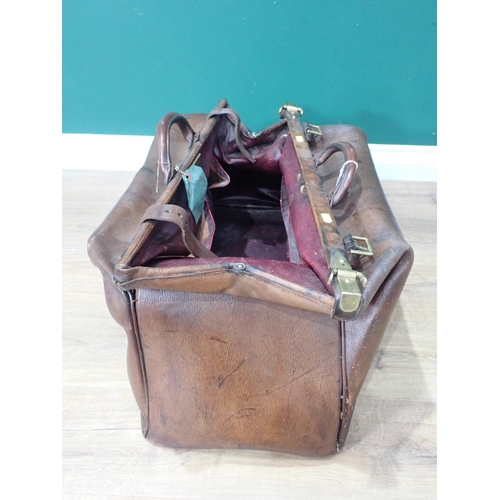 307 - An old leather Doctor's Bag with brass fittings and a Tea Trolley on barley twist supports