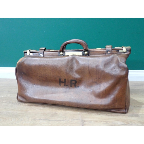 307 - An old leather Doctor's Bag with brass fittings and a Tea Trolley on barley twist supports