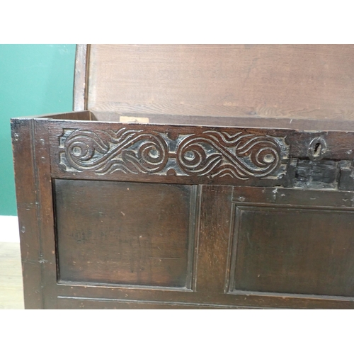 340 - A 17th Century oak Coffer with moulded plank lid above leafage carved frieze and three panel front 3... 