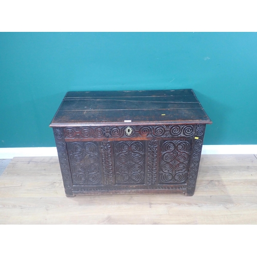 394 - A 17th Century oak Coffer with moulded plank top above scroll carved four panel front 3ft 7in W x 2f... 