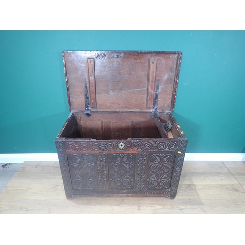 394 - A 17th Century oak Coffer with moulded plank top above scroll carved four panel front 3ft 7in W x 2f... 