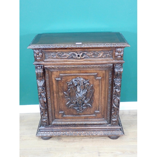 40 - A 19th Century Continental carved oak Cupboard fitted single frieze drawer above single door 3ft 3in... 