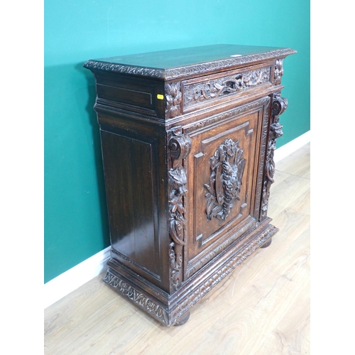 40 - A 19th Century Continental carved oak Cupboard fitted single frieze drawer above single door 3ft 3in... 