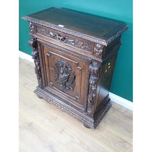 40 - A 19th Century Continental carved oak Cupboard fitted single frieze drawer above single door 3ft 3in... 