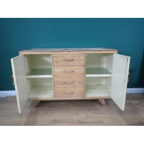 445 - A glass topped Kitchen Cabinet with a pair of applied bamboo cupboard doors flanking four drawers 4f... 