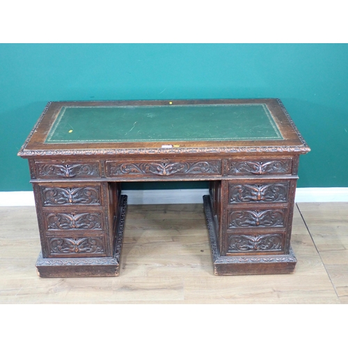 46 - A Victorian oak Pedestal Desk by Edwards & Roberts fitted with nine green man carved drawers 4ft 6in... 