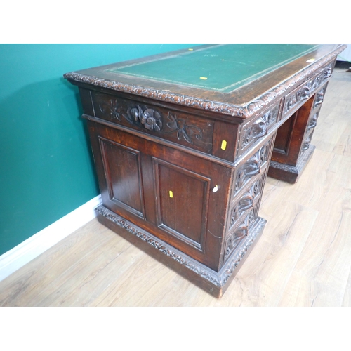 46 - A Victorian oak Pedestal Desk by Edwards & Roberts fitted with nine green man carved drawers 4ft 6in... 