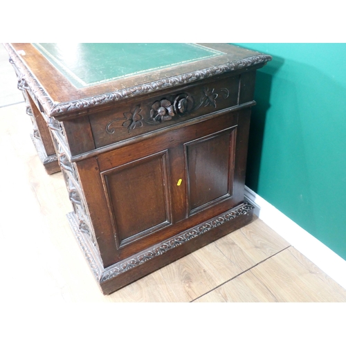 46 - A Victorian oak Pedestal Desk by Edwards & Roberts fitted with nine green man carved drawers 4ft 6in... 