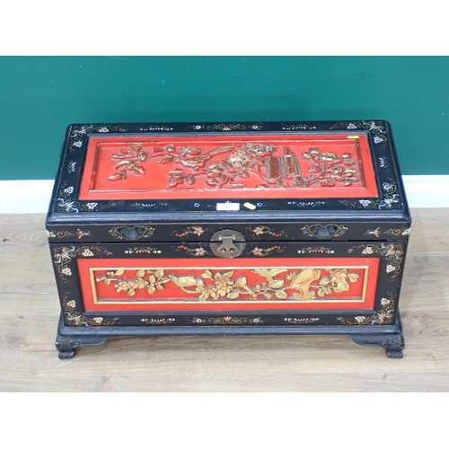 47 - A Chinese lacquered camphorwood Blanket Chest with red and gilded carved panels of birds amongst fol... 