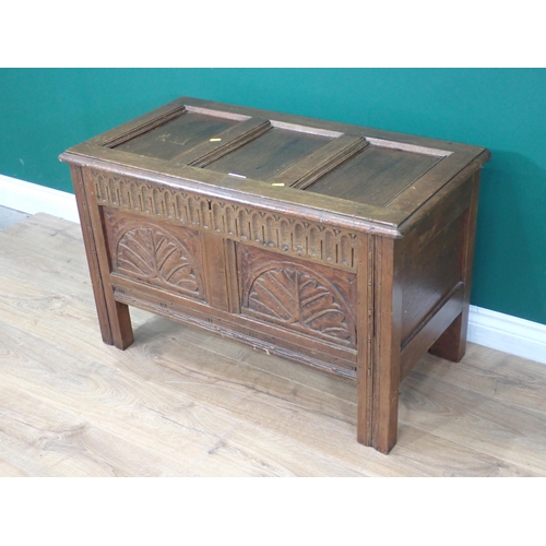 54 - A reproduction oak Coffer with carved two panel front 3ft W x 1ft 10in H