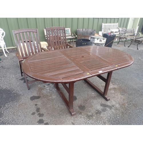 556 - A brown stained Garden Table and two garden Armchairs