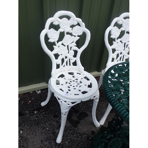 556A - Two heavy white painted metal Garden Chairs with rose design and a green painted metal Garden Table