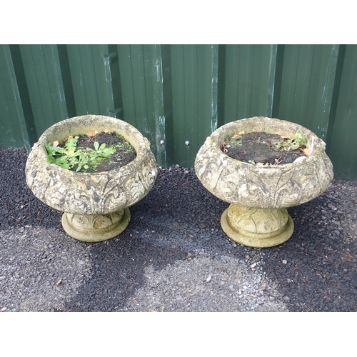 558 - A pair of reconstituted pedestal Garden Urns