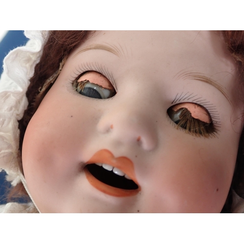 63 - A Heubach Koppelsdorf bisque-headed Doll with sleeping eyes, open
mouth and teeth, 20in L