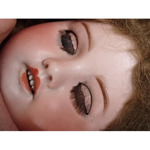 64 - An SFBJ of Paris bisque-headed Doll with sleeping eyes, open mouth and 
teeth, 17in L