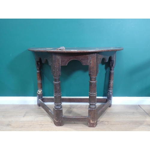 655 - A 17th Century and later oak Credence Table with arched apron mounted on turned supports united by s... 