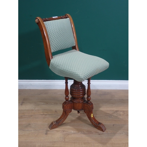 657 - A Victorian walnut Piano Chair