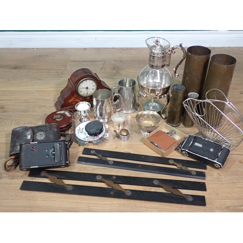 665 - A box containing a glass Ewer on plated stand, two brass Shell Cases, two old Cameras, Surveyor's Me... 