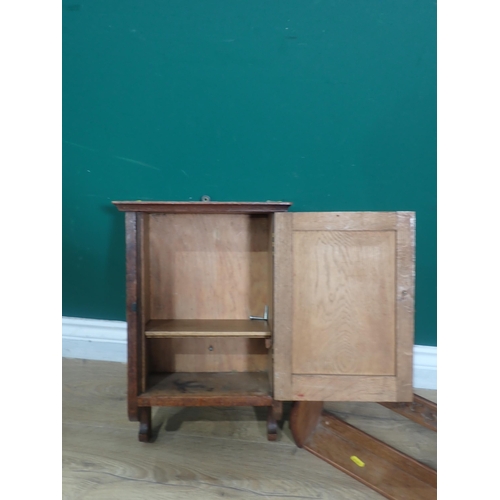 675 - A small Cabinet with single door and a Book Trough