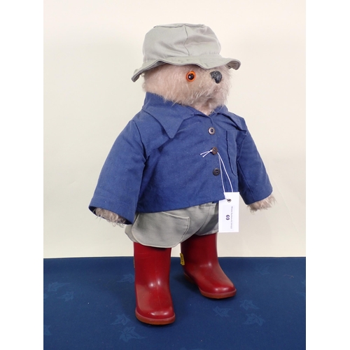 69 - A Paddington Bear, possibly Gabrielle design, with blue jacket and red Dunlop wellingtons, 21in