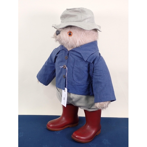 69 - A Paddington Bear, possibly Gabrielle design, with blue jacket and red Dunlop wellingtons, 21in