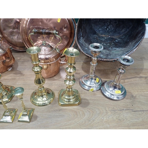 693 - A quantity of brass and silver plated Candle Sticks, two copper Coal Scuttles, two copper Kettles an... 