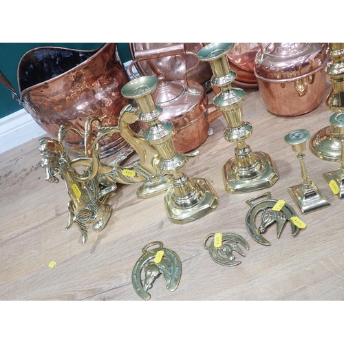 693 - A quantity of brass and silver plated Candle Sticks, two copper Coal Scuttles, two copper Kettles an... 