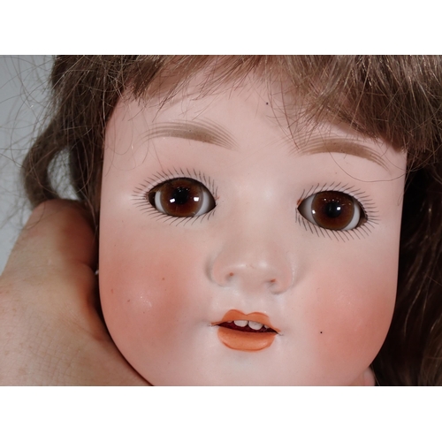 74 - A Schoenau Hoffmeister Doll stamped 914, with bisque head, sleeping eyes, open mouth and teeth, 28in... 