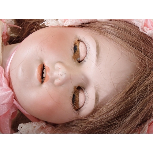 75 - A Schoenau and Hoffmeister bisque headed Doll, marked 1909, with sleeping eyes, open mouth and teeth... 