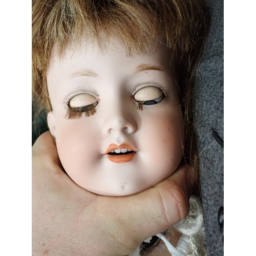 76 - An Armand Marseille bisque-headed Doll with sleeping eyes, open mouth
and teeth, composition arms an... 