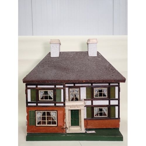 88 - A Doll's House in the style of timber and brick, with hinged doors and containing large large quanti... 