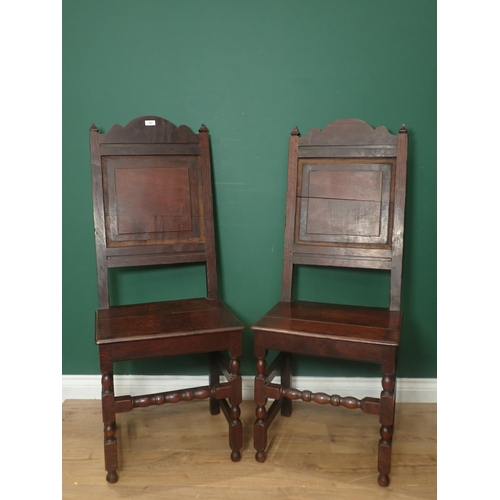 223 - A pair of late 17th Century oak panel back Chairs with solid seats on turned and square front legs