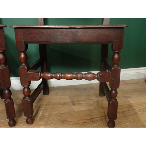 223 - A pair of late 17th Century oak panel back Chairs with solid seats on turned and square front legs