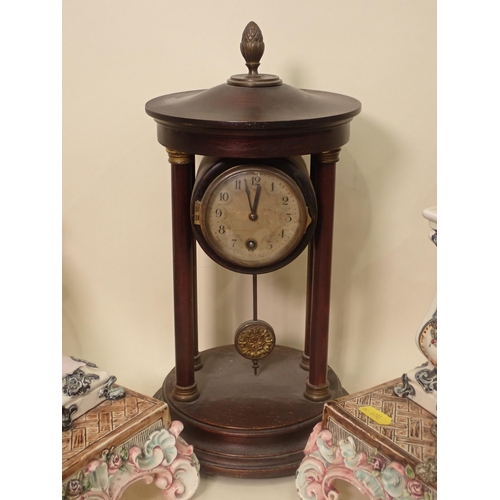 605 - A wooden Mantle Clock with pineapple finial mounted on turned columns, a pair of continental ceramic... 