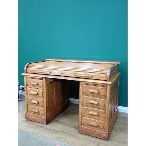 585 - An oak tambour fronted Desk fitted eight drawers (tambour front split) 4ft 5in W x 3ft H