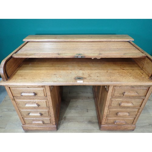 585 - An oak tambour fronted Desk fitted eight drawers (tambour front split) 4ft 5in W x 3ft H