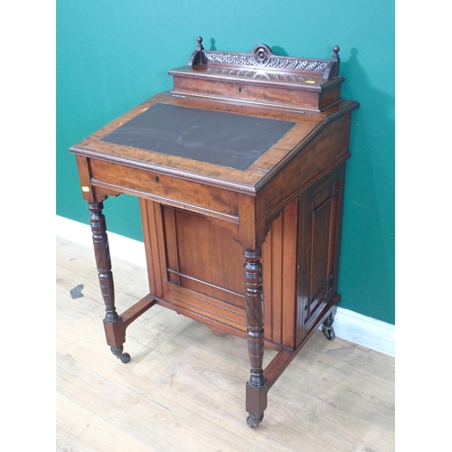 687 - A late Victorian Davenport Desk, fitted cupboard door to the side enclosing drawers and raised on ca... 