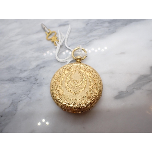 218 - An 18ct gold cased open faced key wind Pocket Watch the floral engraved dial with roman numerals, pl... 