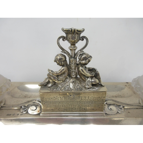 110 - A Victorian silver Inkstand of shaped rectangular form fitted two frosted glass inkwells with silver... 