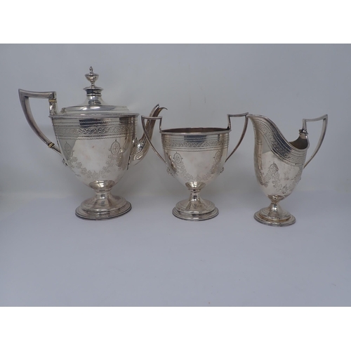 114 - A Victorian silver three-piece Coffee Service engraved floral swags and paterae, mask handles on bea... 