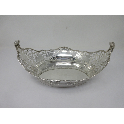 120 - A George V silver pierced oval Basket with rope twist border and scroll finials, London 1928, 490gms