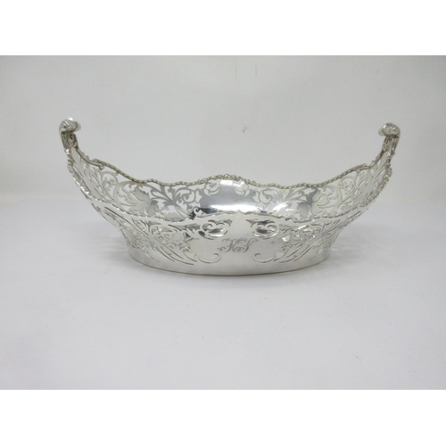 120 - A George V silver pierced oval Basket with rope twist border and scroll finials, London 1928, 490gms