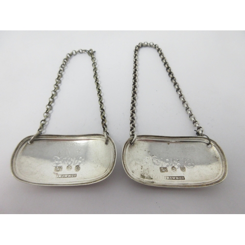 14 - A pair of George III silver oval Labels, Rum and Shrub, Sheffield 1817, maker: Kirkby, Waterhouse & ... 