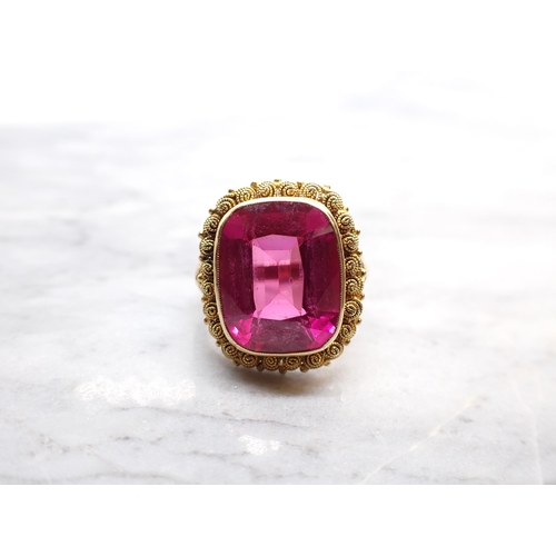 251 - A synthetic Ruby Ring millegrain-set large cushion-cut stone in cannetille frame, stamped 585, ring ... 