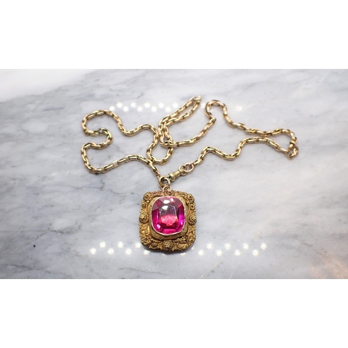 252 - A synthetic Ruby Pendant in cannetille frame, Continental marks, on yellow metal chain