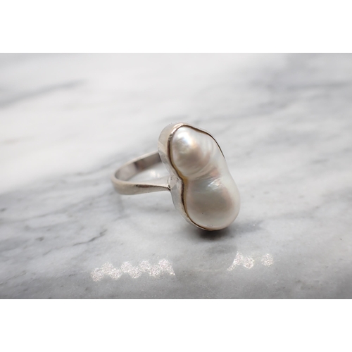 255 - A contemporary Baroque Pearl Ring collet-set single pearl in white gold stamped 585, ring size K/L