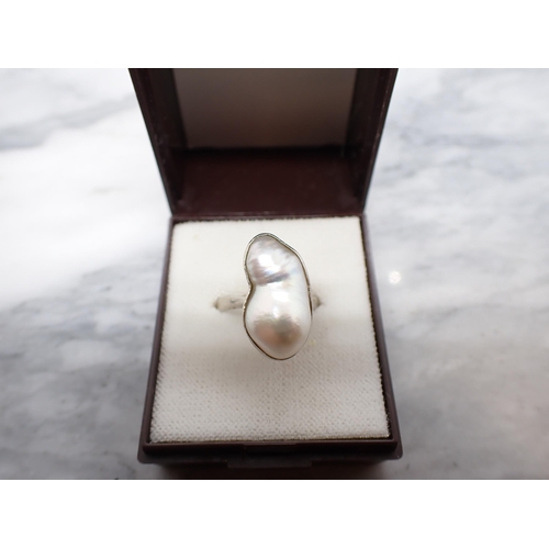 255 - A contemporary Baroque Pearl Ring collet-set single pearl in white gold stamped 585, ring size K/L