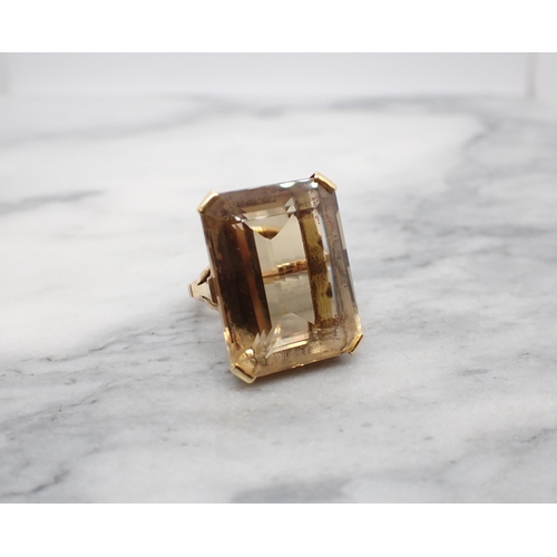 276 - A large Citrine Dress Ring corner claw-set emerald-cut stone in pierced mount, unmarked, untested, r... 